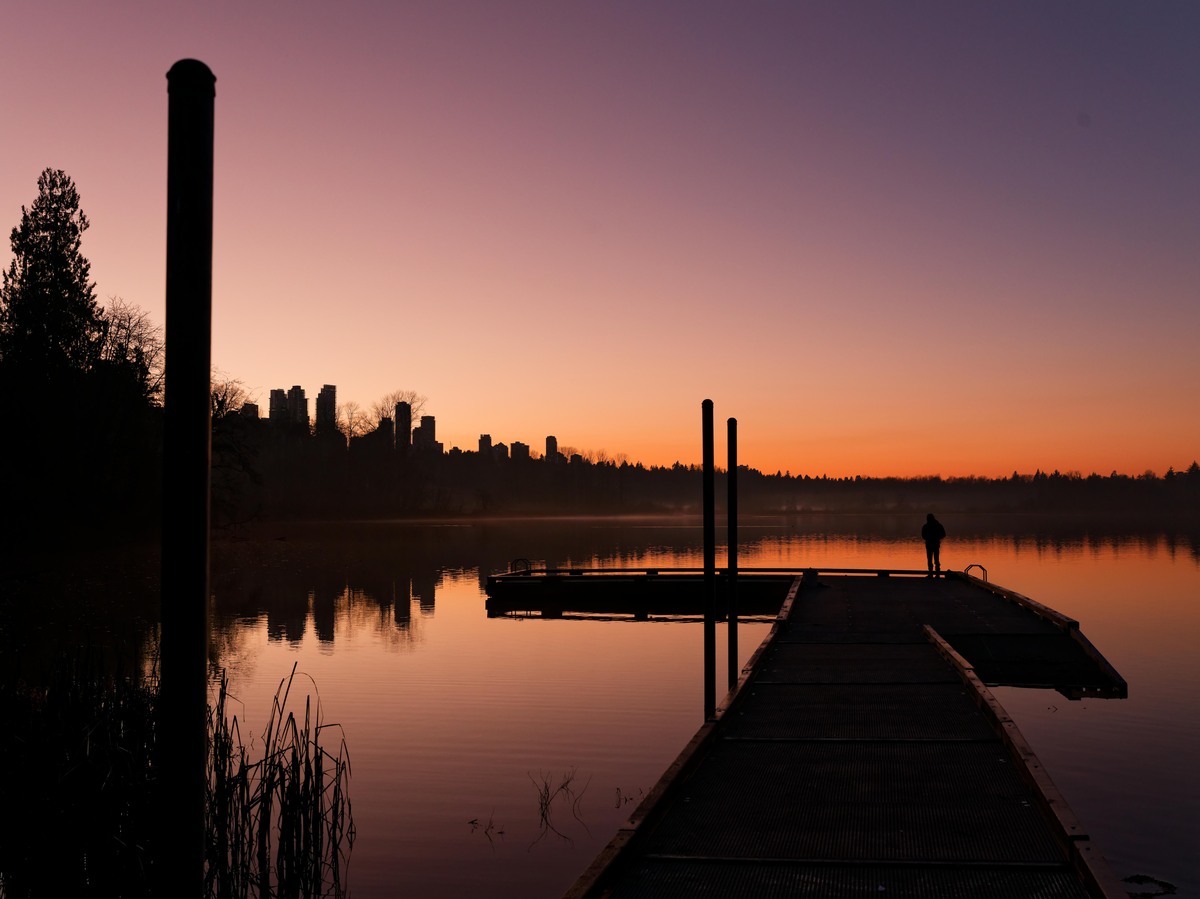 Delta BC - sunset over the water with a person on a dock