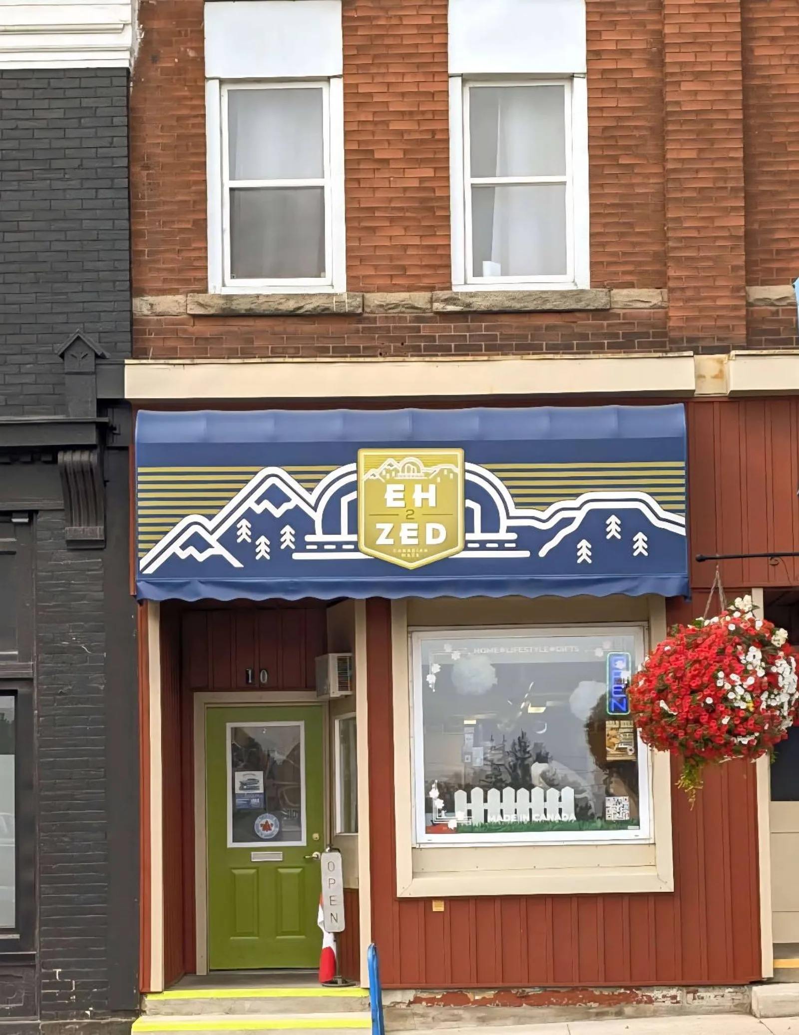 EH 2 ZED: Exterior of the EH 2 ZED shop in Harriston, Ontario, with its blue-and-yellow storefront sign.